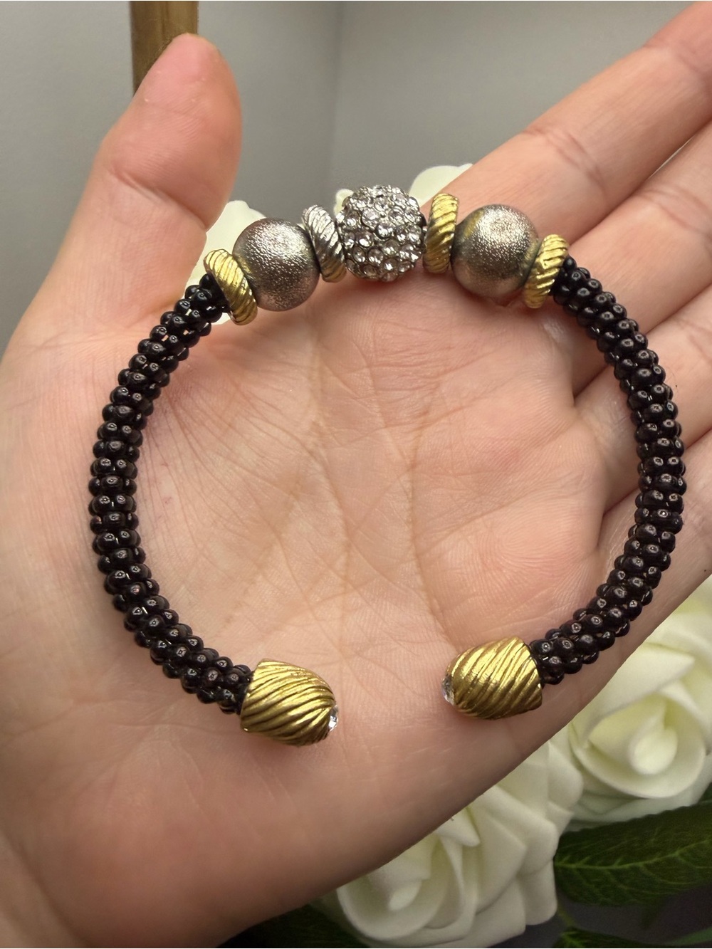 Elegant Black Beaded Bracelet with Gold and Silver Accents